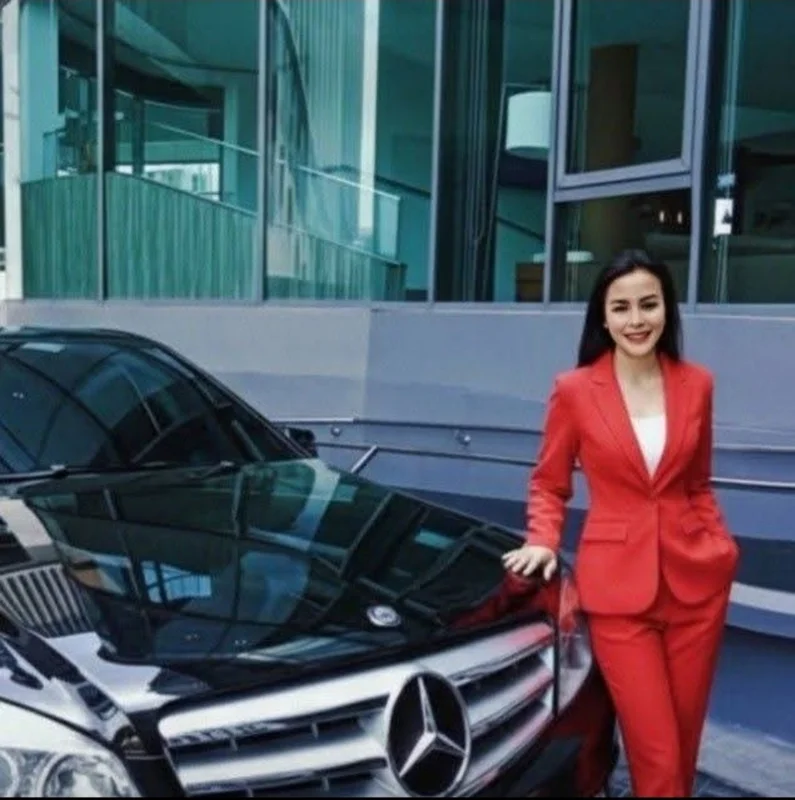 Owner of the recommended airport taxi service beside a vehicle